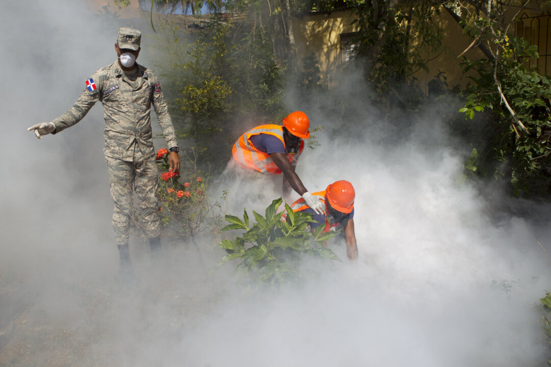 Dominican Air Force personnel fumigate various locations in Santo Domingo against the Aedes aegypti mosquito, vector of the Zika virus, on Jan. 23, 2016. (Erika Santelices/AFP/Getty Images)