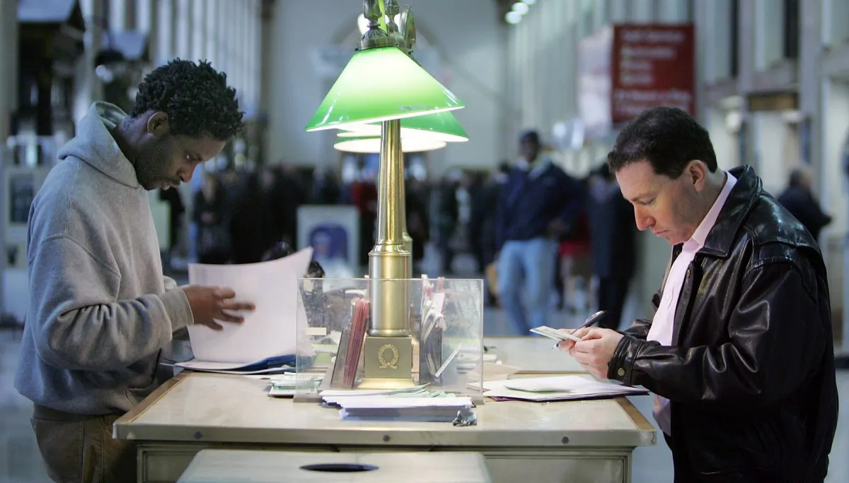 Kareem Lake (L) and Steve Harrison prepare their tax forms for mailing at the James A. Farley Post Office building in New York City April 17, 2007. (Mario Tama/Getty Images)