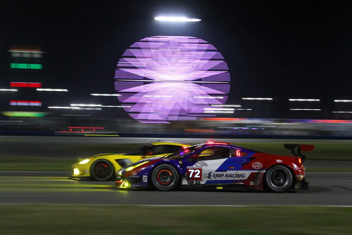 The #72 SMP Racing Ferrari Battle on of the Corvettes entering the International Horseshoe just before the halfway point of the 2016 Rolex 24 at Daytona. (Chris Jasurek/Epoch Times)