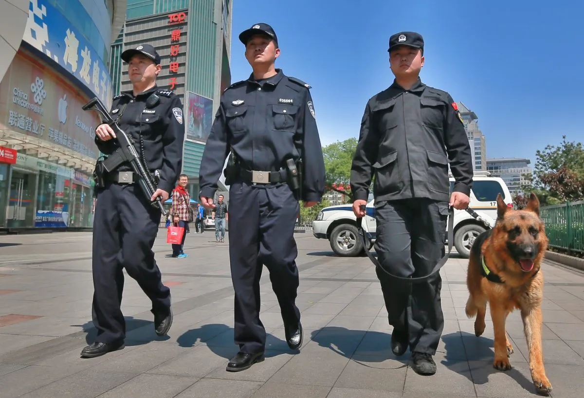 Armed police officers patrol a street with a police dog on May 12, 2014 in Beijing, China. (Photo by ChinaFotoPress/ChinaFotoPress via Getty Images)