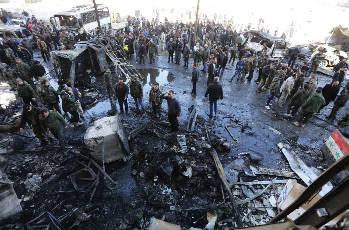 Syrian pro-government forces and residents gather at the site of suicide bombings in the area of a revered Shiite shrine in the town of Sayyida Zeinab, on the outskirts of the capital Damascus, on Jan. 31, 2016. The Islamic State group claimed responsibility for the bombings that killed at least 45 people. (Louai Beshara/AFP/Getty Images)
