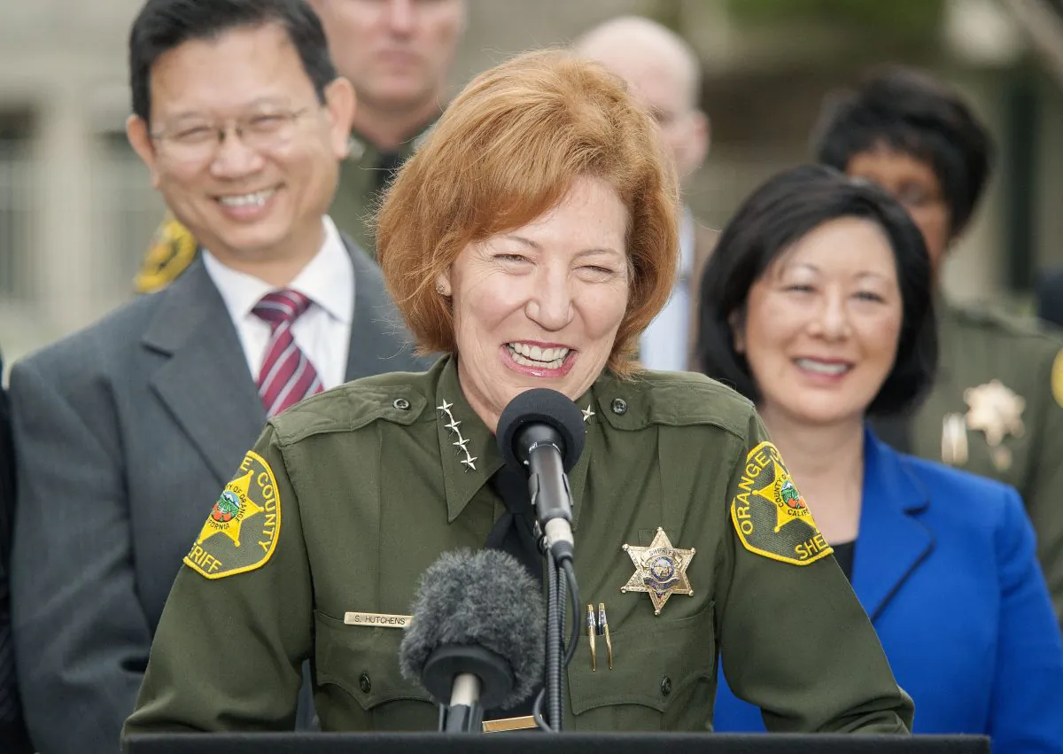 Orange County Sheriff Sandra Hutchens is all smiles as she answers questions about the capture of both outstanding jail escapees Hossein Nayeri and Jonathan Tieu are in the custody of the San Francisco during a news conference outside Orange County Sheriff's Department headquarters in Santa Ana on Saturday, Jan. 30, 2016. (Ken Steinhardt/The Orange County Register via AP)