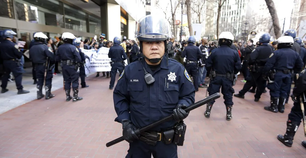 San Francisco police officers keep protesters from marching toward the entrance to Super Bowl City Saturday, Jan. 30, 2016, in San Francisco. (AP Photo/David J. Phillip)