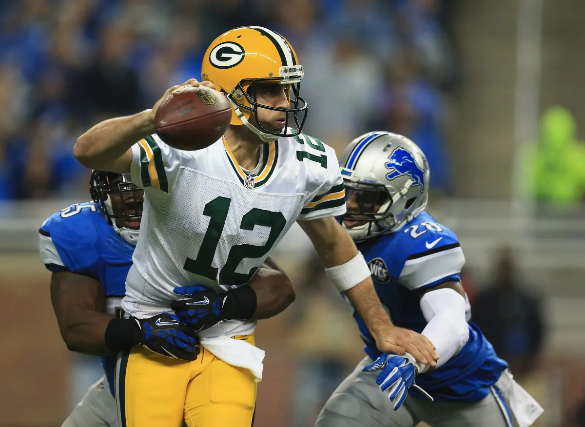 Aaron Rodgers (C) of the Green Bay Packers played a memorable game against the Detroit Lions on Dec. 3, 2015 when his 61-yard throw found teammate Richard Rodgers in the end zone for the last-second win. (Andrew Weber/Getty Images)