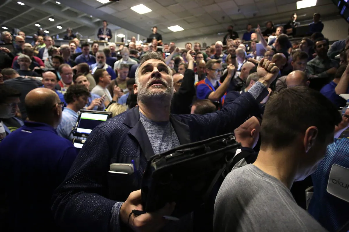 CHICAGO, IL - DECEMBER 16 : Traders in the Standard & Poor's 500 stock index options pit at the Chicago Board Options Exchange (CBOE) react after it was announced that they Federal Reserve would increase interest rates December 16, 2015 in Chicago, Illinois. The Federal Reserves raised the interest rates for the first time since 2006 by 0.25 percentage points. (Photo by Joshua Lott/Getty Images)