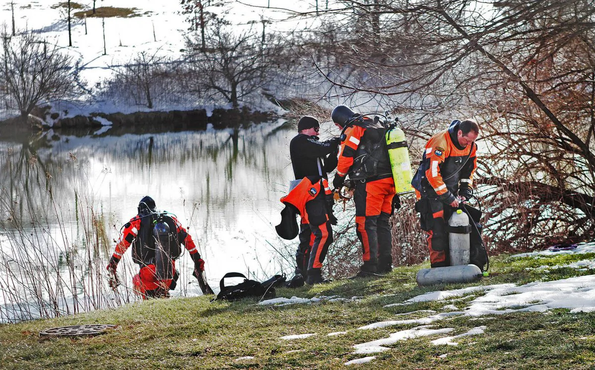 In this Jan. 31, 2016 photo, troopers prepare to search the Duck Pond in Blacksburg, Va. (Edmee Rodriguez/The Roanoke Times via AP)