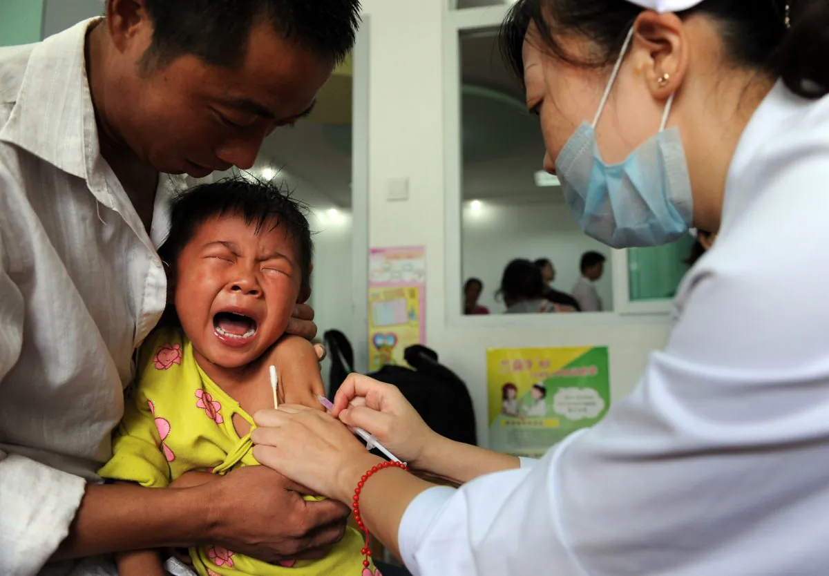 A Chinese boy screams out in pain as he gets inoculated against measles in eastern China’s Anhui province on Sept. 11, 2010. Police stopped an illegal business selling tainted vaccines in Shandong Province. (STR/AFP/Getty Images)