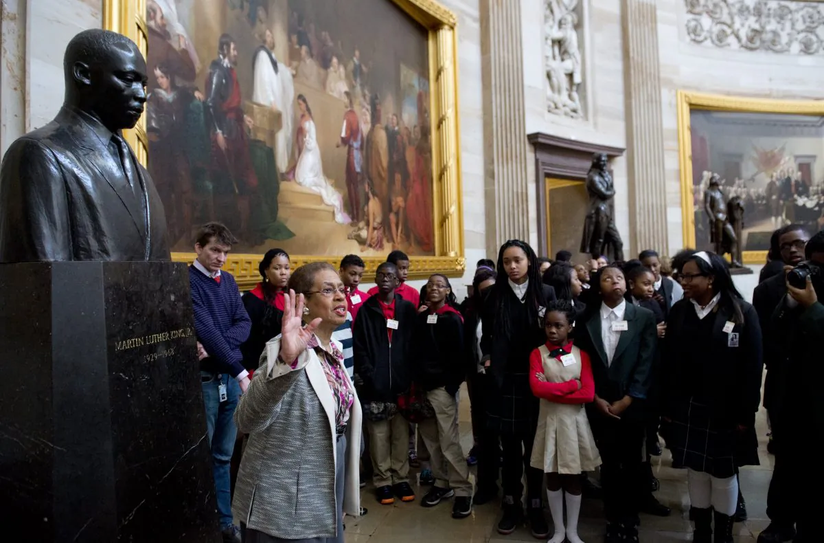 U.S. Congressional Delegate Eleanor Holmes Norton speaks with students about Black History Month alongside a statue of Martin Luther King Jr., during a tour of the Rotunda at the U.S. Capitol in Washington, D.C., on Feb. 20, 2014. (Saul Loeb/AFP/Getty Images)