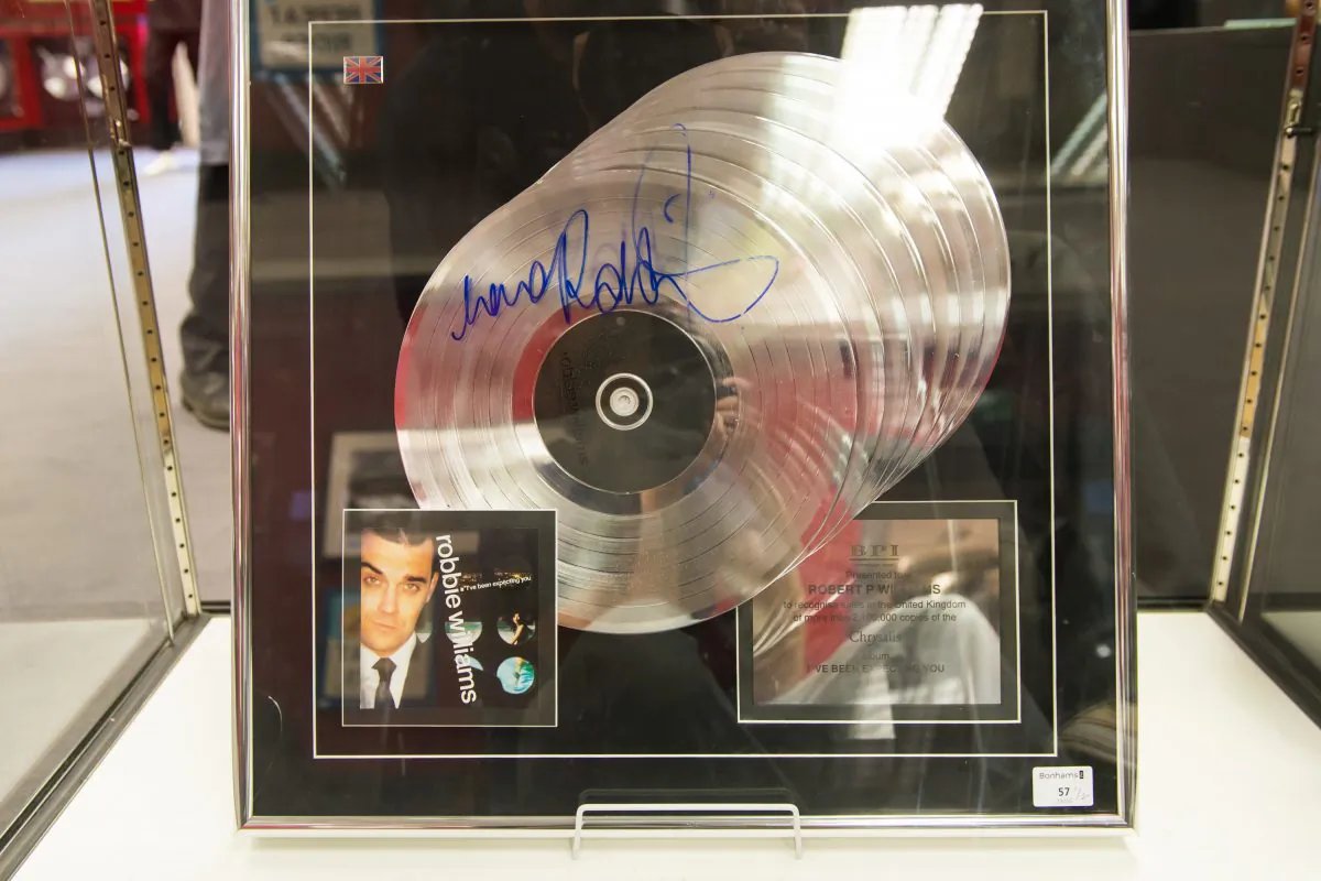 A multi platinum award for the album "I've Been Expecting You" signed by Robbie Williams is seen at the press review before the auction of Robbie Williams memorabilia in aid of the Donna Louise Children's Hospice at Bonhams on July 15, 2015 in London, England. (Ian Gavan/Getty Images)