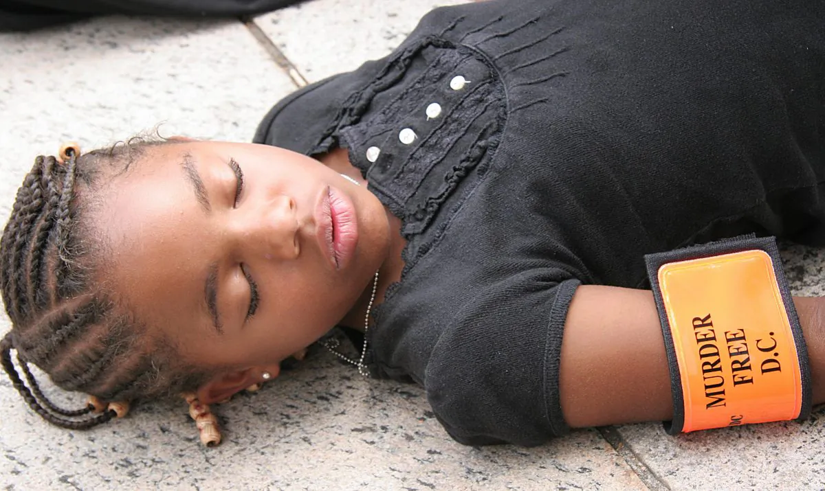 Radiance Hunter, 9-years-old lies "dead" in protest 24 July, 2007 during a protest outside the US District Courthouse in Washington, DC. (Karen Bleier/AFP/Getty Images)