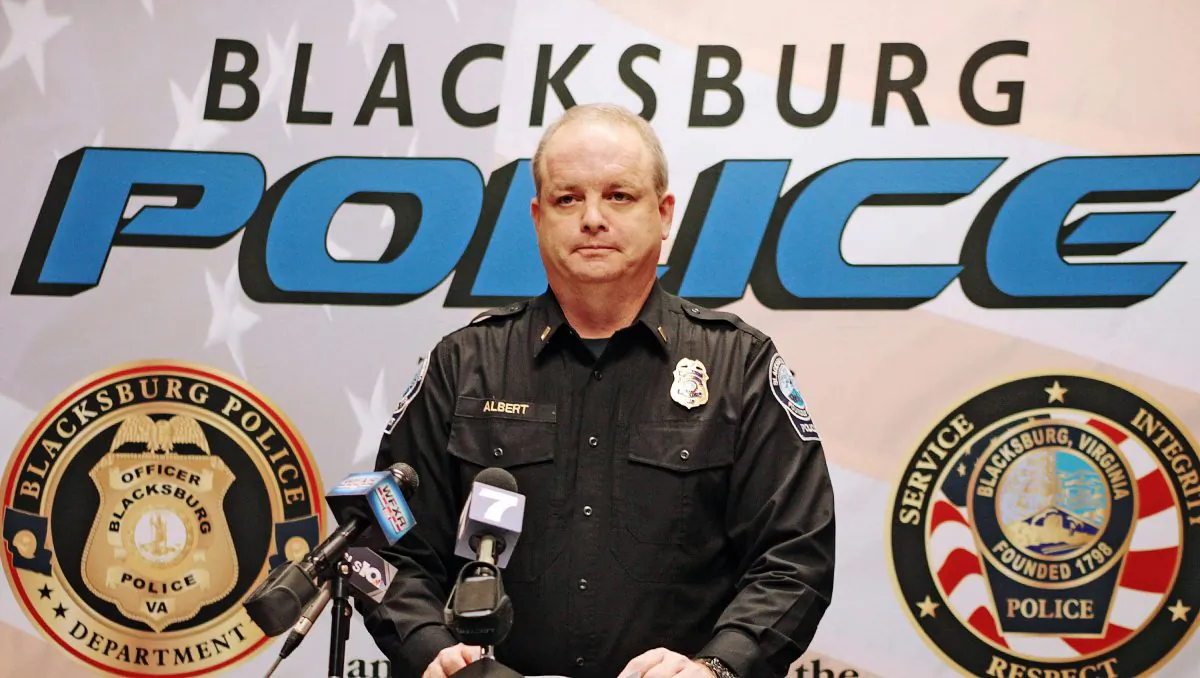 In this Jan. 31, 2016 photo, Blacksburg Lieutenant Mike Albert announces that Virginia Tech student Natalie Keepers was arrested in connection to the death of Nicole Madison Lovell, in Blacksburg, Va. (Edmee Rodriguez/The Roanoke Times via AP) 