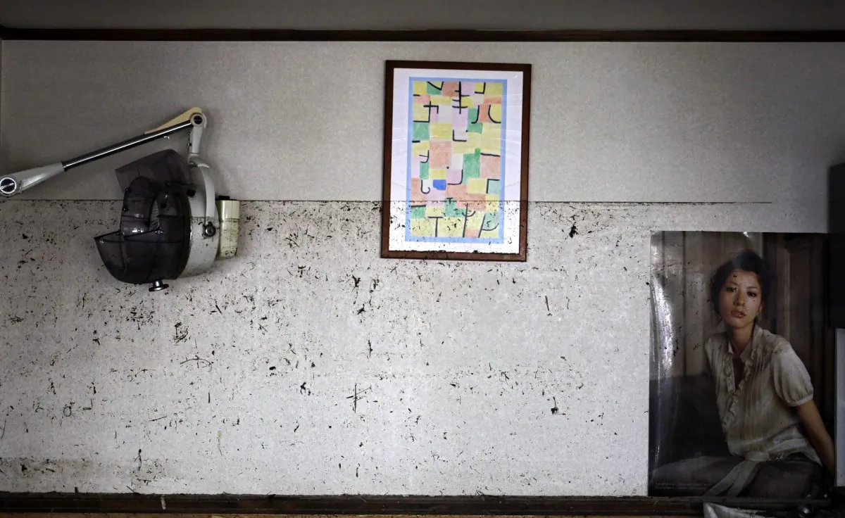 The waterline from the March 11 tsunami is left on the wall at the barber shop in Ishinomaki, Miyagi Prefecture, northeastern Japan, Saturday, April 16, 2011. The water in many places along Japan's northeastern Pacific coast struck by tsunami rose above head level, and everything below the waterline was destroyed or left covered by mud. (AP Photo/Sergey Ponomarev)