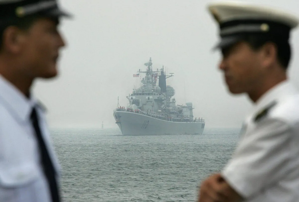 Chinese Navy officers wait dockside as a Chinese Navy warship escorting the arrival of the USS Curtis Wilbur (DDG54) arrives at Qingdao port, in Qingdao, in eastern China's Shandong Province, on Sept. 13, 2005. (Frederic J. Brown/AFP/Getty Images)