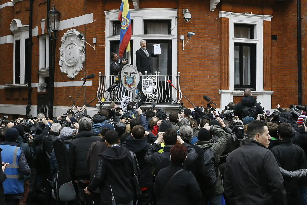 Wikileaks founder Julian Assange. holding a U.N. report speaks on the balcony of the Ecuadorean Embassy in London on Feb. 5, 2016. (AP Photo/Kirsty Wigglesworth)