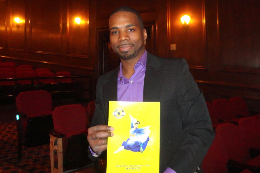Renell Edwards holds the Shen Yun program book at the Rochester Auditorium Theatre after the performance on Feb. 6, 2016. (Madalina Hubert/Epoch Times)