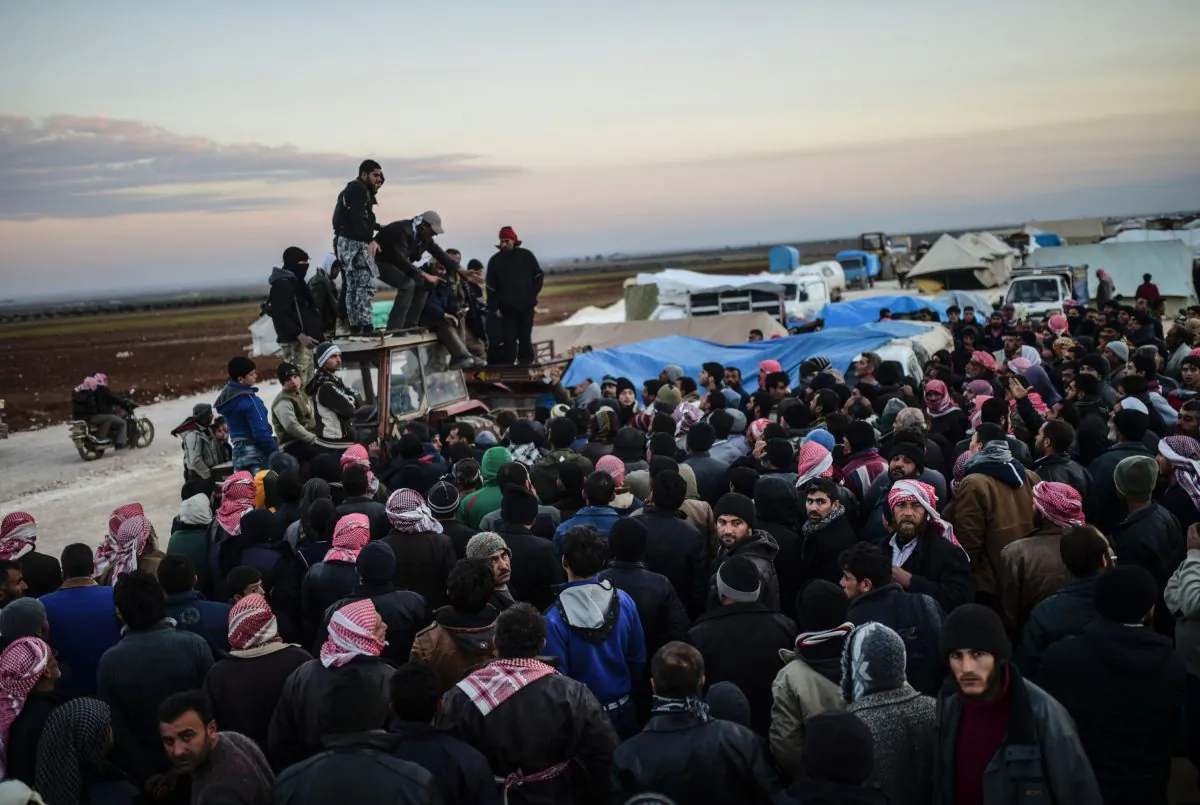 Syrians fleeing the northern embattled city of Aleppo wait on Feb. 5, 2016 in Bab-Al Salama, next to the city of Azaz, northern Syria, near Turkish crossing gate. Nearly 40,000 Syrian civilians have fled a regime offensive near Aleppo, a monitor said, as Turkey warned it was bracing for a wave of tens of thousands of refugees. (Bulent Kilic/AFP/Getty Images)