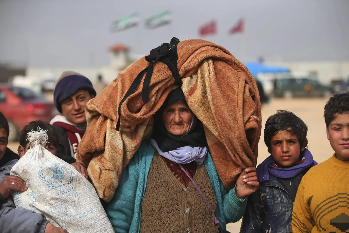 Syrians, some carrying belongings, head towards the Bab al-Salam border crossing with Turkey, in Syria, on Feb. 6, 2016. Thousands of Syrians have rushed toward the Turkish border, fleeing fierce Syrian government offensives and intense Russian airstrikes. Turkey has promised humanitarian help for the displaced civilians, including food and shelter, but it did not say whether it would let them cross into the country. (AP Photo/Bunyamin Aygun)