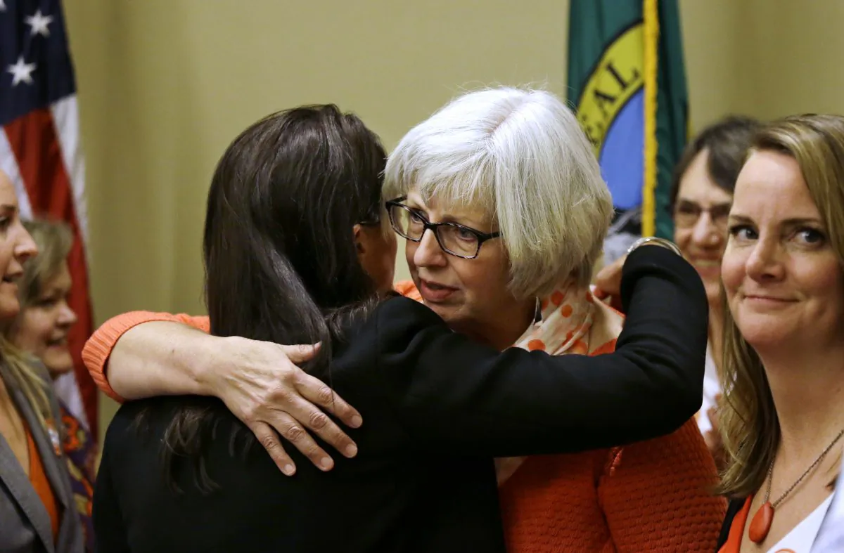 Jane Weiss, whose niece was shot and killed in the May 2014 shooting near the campus of UC Santa Barbara (R) is embraced by Cindy Gazecki, aunt of a high school shooting victim, following a news conference where they called on members of the Legislature to take action on proposed laws to help reduce gun violence in Olympia, Wash., on Jan. 21, 2016. Lawmakers in Washington state were to begin discussions later in the day on a list of gun-control measures that include requiring safe storage of firearms to avoid tragedies like the Marysville high school shooting and prohibiting law enforcement agencies from selling confiscated guns. (AP Photo/Elaine Thompson)