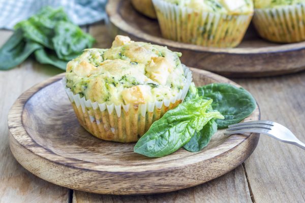 Freshly baked snack muffins with spinach and feta cheese