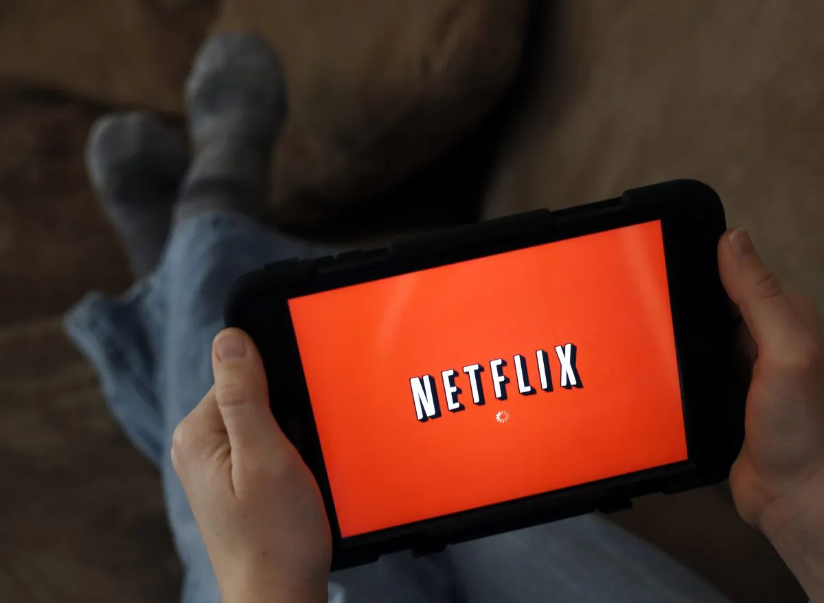 A person displays Netflix on a tablet in North Andover, Mass., on Jan. 17, 2014. (AP Photo/Elise Amendola)