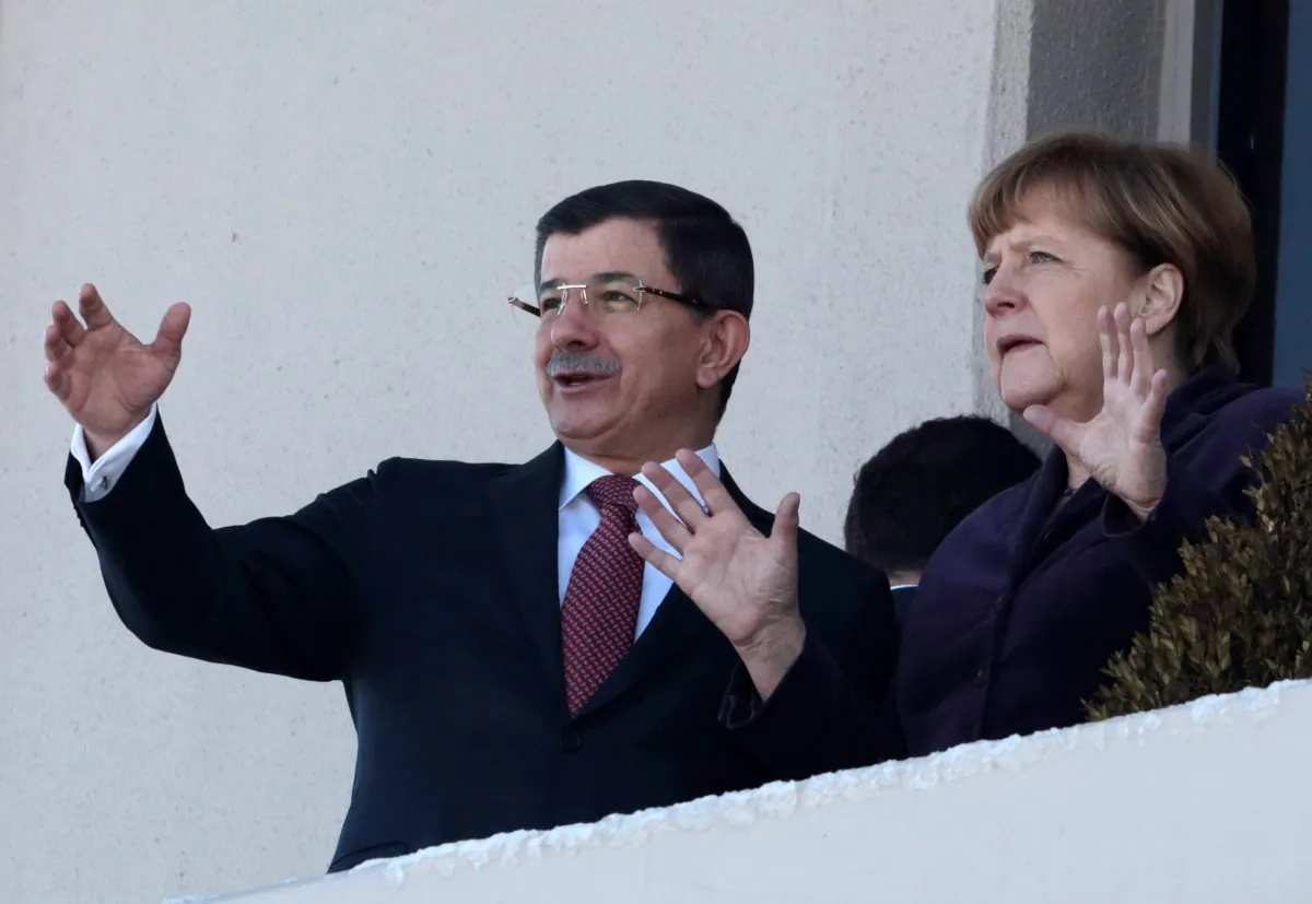 German Chancellor Angela Merkel (R) and Turkish Prime Minister Ahmet Davutoglu after a welcome ceremony in Ankara, Turkey, on Feb. 8, 2016. Merkel is meeting Davutoglu and other Turkish officials for talks on reducing the influx of migrants to Europe. Turkey, a key country on the migrant route to Europe, is central to Merkel's diplomatic efforts to reduce the flow. (AP Photo/Burhan Ozbilici)