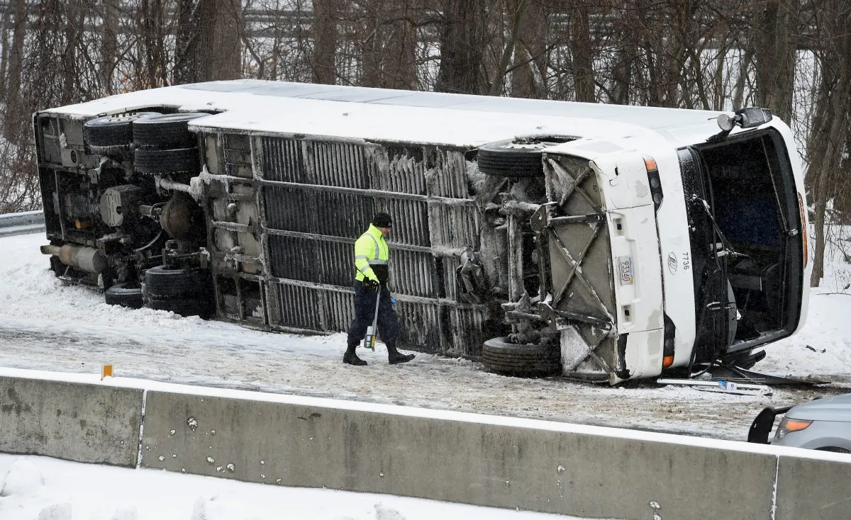 A Connecticut State Police officer investigates an overturned casino-bound tour bus on I-95 North near exit 61 in Madison, Conn., on Feb. 8, 2016. At least 30 people were injured, several critically, in the accident. The bus was traveling from New York City to the Mohegan Sun casino in Uncasville, Conn. (Arnold Gold/New Haven Register via AP)