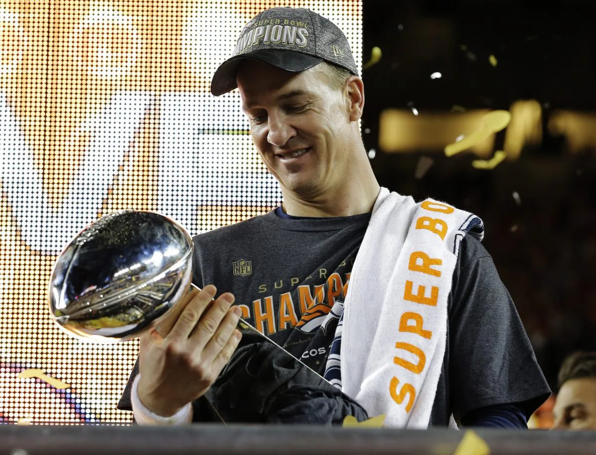 Denver Broncos Peyton Manning holds up the trophy after the NFL Super Bowl 50 football game Sunday, Feb. 7, 2016, in Santa Clara, Calif. The Broncos beat the Panthers 24-10.  (AP Photo/David J. Phillip)