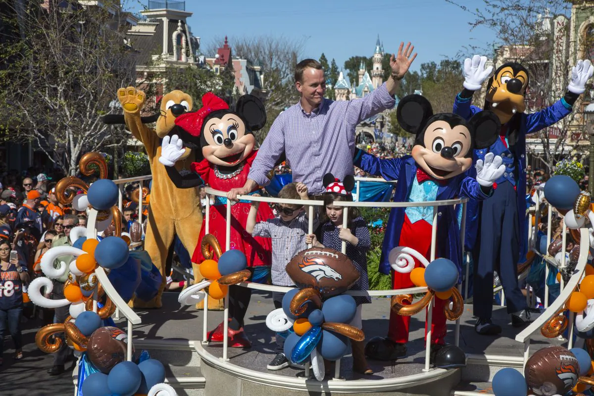 Peyton Manning joined the Disney characters in a float with his children, Mosely and Marshall. (Paul Hiffmeyer/Disneyland Resort via Getty Images)
