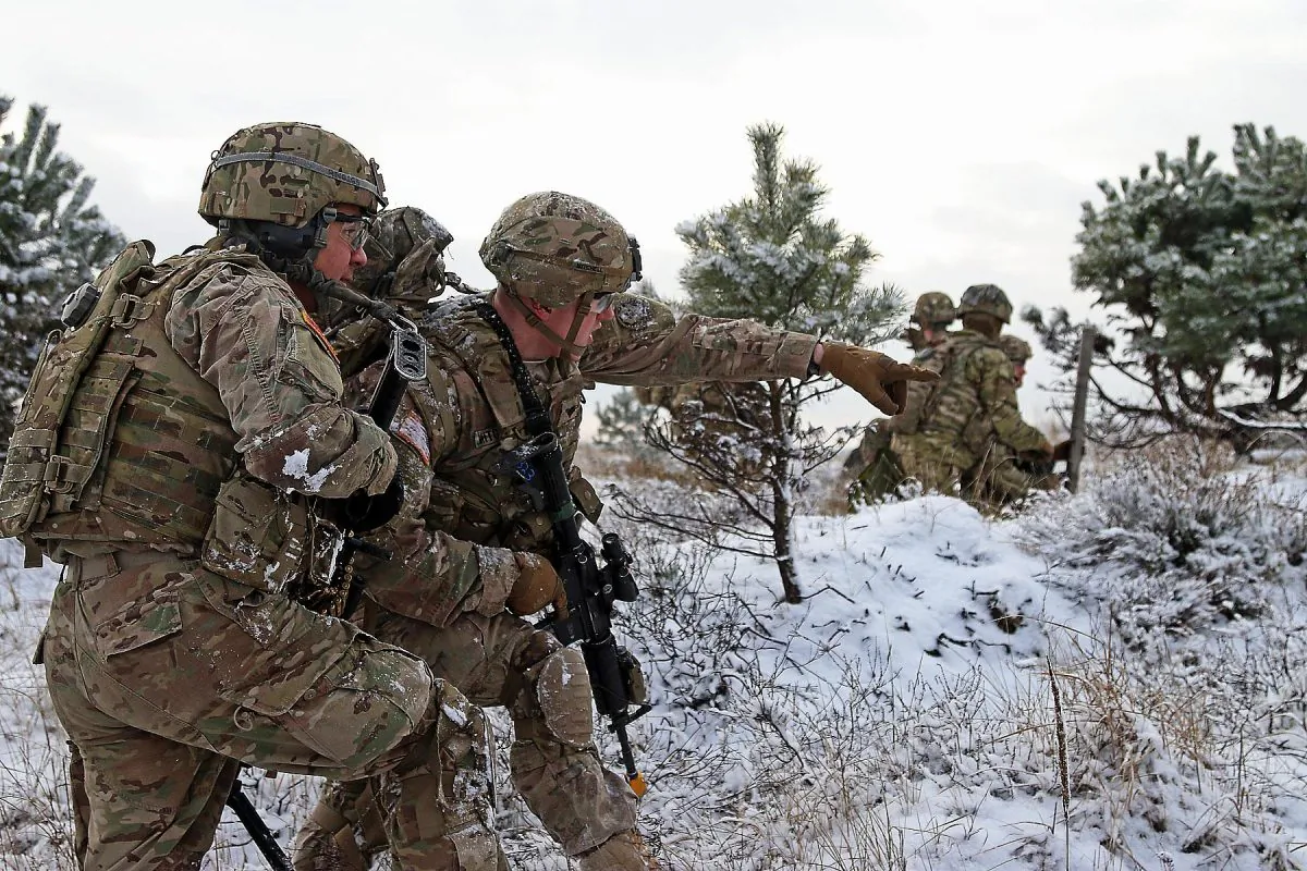 Army Spc. Ethan Mitchell (R) points out an objective to Army Spc. Raymon Najera during a live-fire exercise in Konotop, Poland, on Jan. 18. The U.S. military is increasing its presence in Europe, to counter increased aggression from Russia. (Sgt. Paige Behringer/U.S. Army)