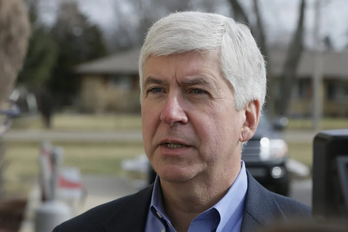 Michigan Gov. Rick Snyder is interviewed after visited a church that's distributing water and filters to its predominantly Latino parishioners in Flint, Mich., on Feb. 5, 2016. (AP Photo/Carlos Osorio)