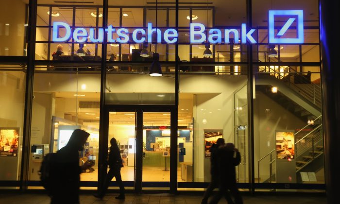 People walk past a branch of Deutsche Bank in Berlin, Germany on Feb. 9, 2016. (Sean Gallup/Getty Images)