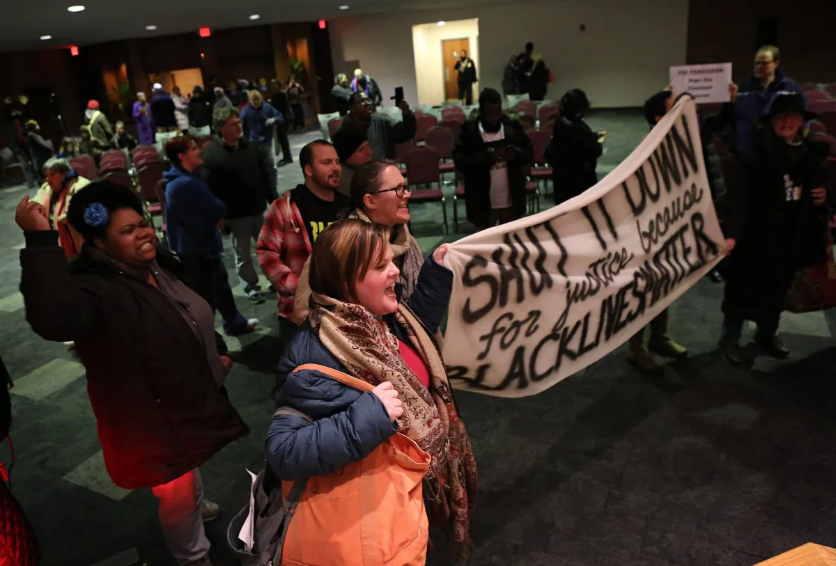 Protesters chant and yell after the Ferguson, Mo., city council meeting in Ferguson on Feb. 9, 2016, where the council voted to approve a modified consent decree with the United States Department of Justice. It is unclear if the Department of Justice will agree to the modifications. (David Carson/St. Louis Post-Dispatch via AP)