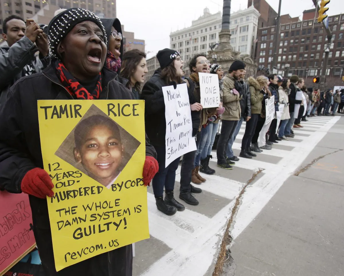 FILE- In this Nov. 25, 2014, file photo, 

Demonstrators in Cleveland during a protest over the police shooting of 12-year-old Tamir Rice, on Nov. 25, 2014. (AP Photo/Tony Dejak, File)