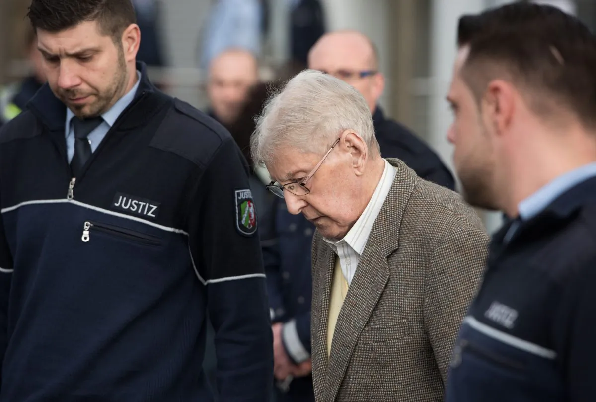94-year-old former SS guard at the Auschwitz death camp Reinhold Hanning, center, leaves the building after the opening of his trial in Detmold, Germany, Thursday, Feb. 11, 2016. (Bernd Thissen/Pool Photo via AP)