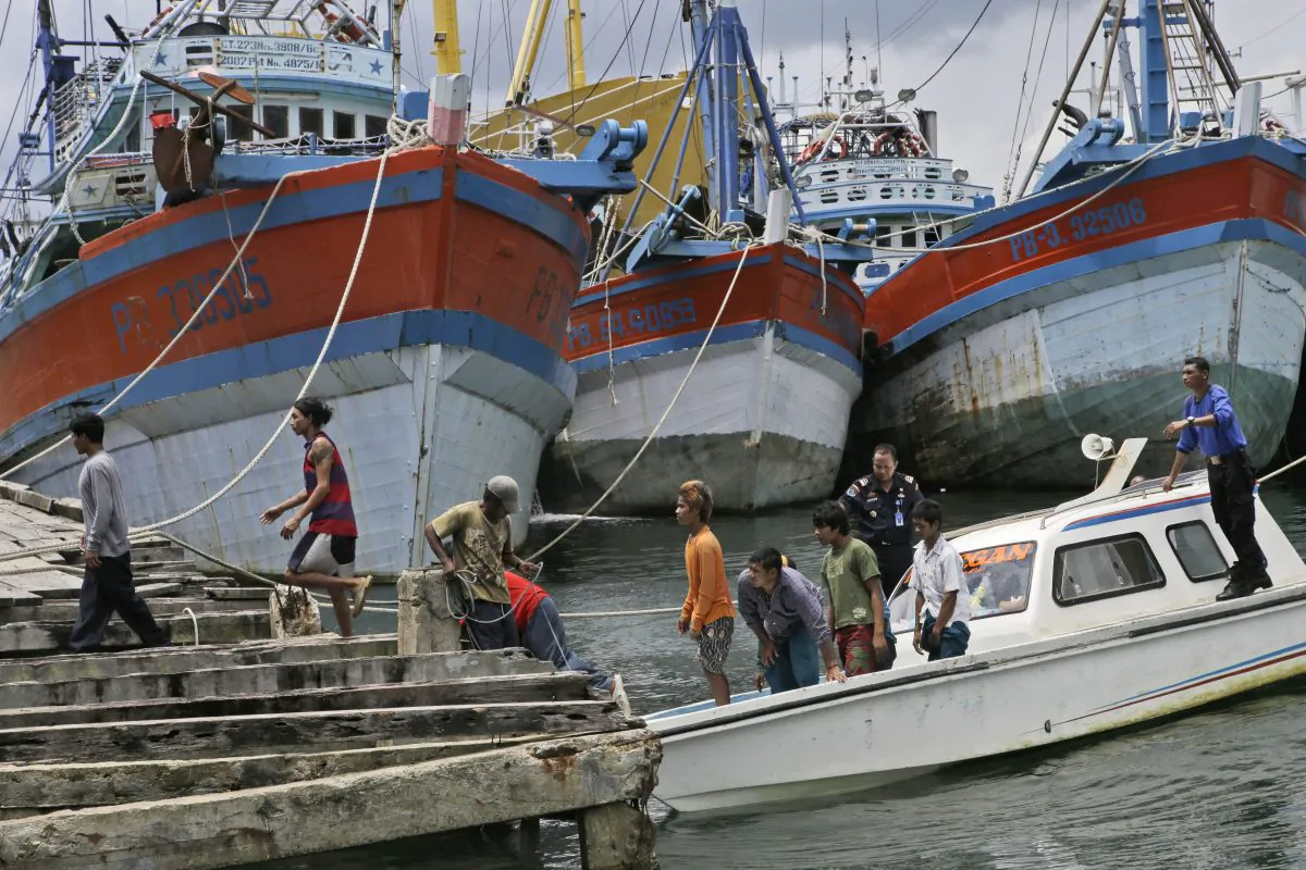 Burmese fishermen arrive at the compound of Pusaka Benjina Resources to report themselves for departure to leave the fishing company in Benjina, Aru Islands, Indonesia, on April 3, 2015. (AP Photo/Dita Alangkara)
