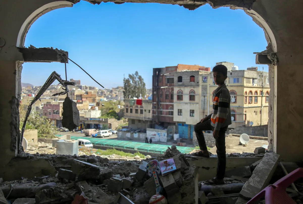 A Yemeni boy checks the damage following a mortar shell attack on the country's flashpoint southern city of Taez on Feb. 3, 2016. (Ahmad al-Basha/AFP/Getty Images)