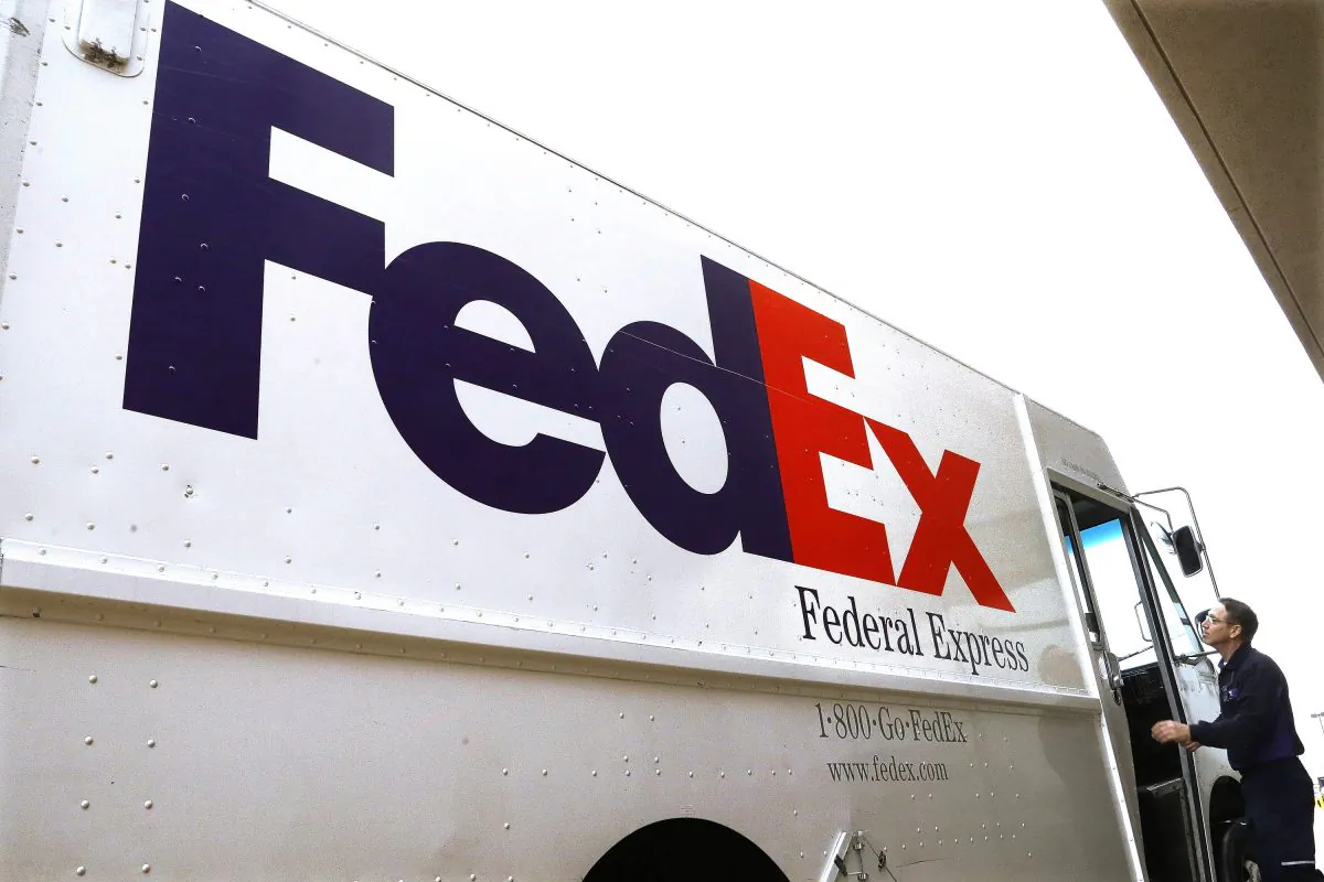 A Federal Express delivery truck driver returns to his truck after delivering a package to a business, in Springfield, Ill., on Dec. 18, 2014. (AP /Seth Perlman)
