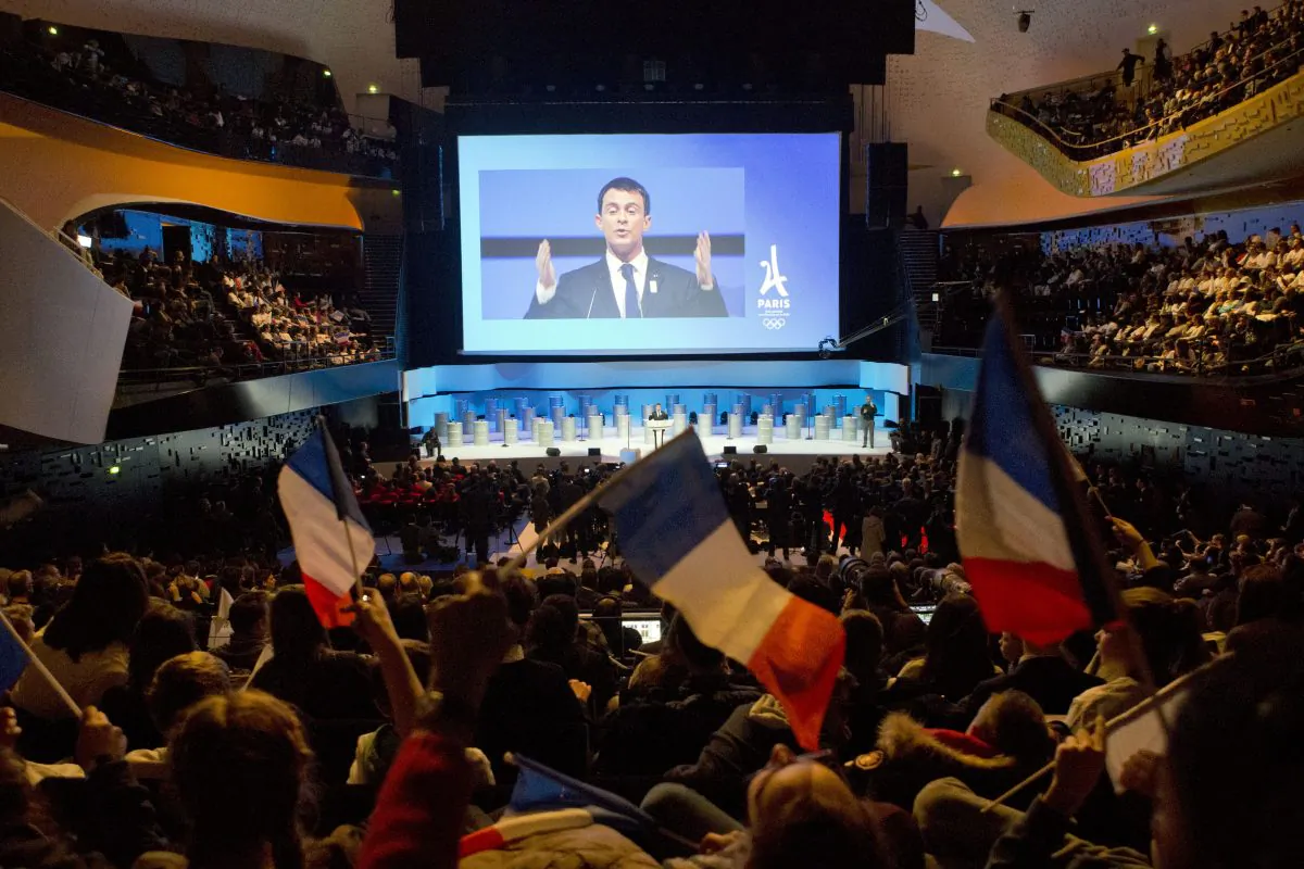French Prime Minister Manuel Valls, projected on a giant screen, delivers his speech during the official presentation of Paris as candidate for the 2024 Olympic summer games in Paris, France, on Feb. 17, 2016. Paris, which hosted the Olympics in 1900 and 1924, is competing against Budapest, Rome and Los Angeles for the games. The International Olympic Committee will choose the host city in September 2017. (AP Photo/Francois Mori)