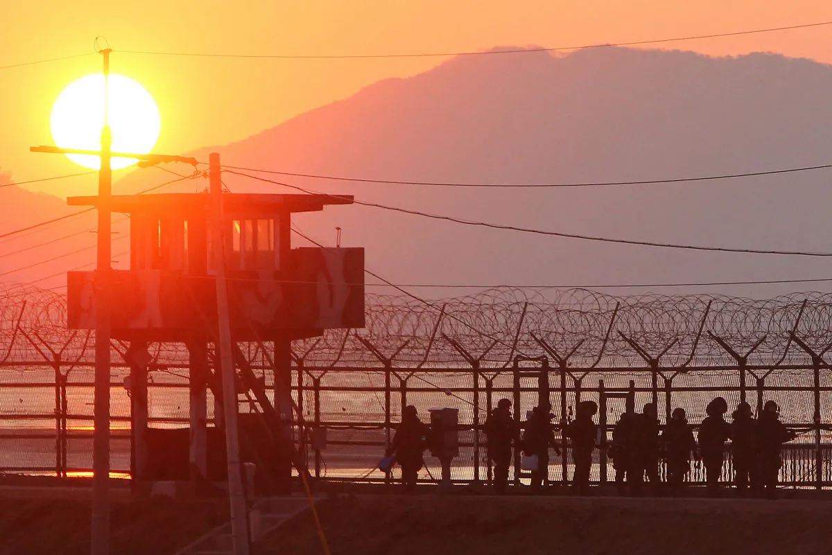 South Korean soldiers patrol along iron fence in Paju near the Demilitarized Zone (DMZ) dividing the two Koreas on Dec. 19, 2011. (Yonhap/AFP/Getty Images)