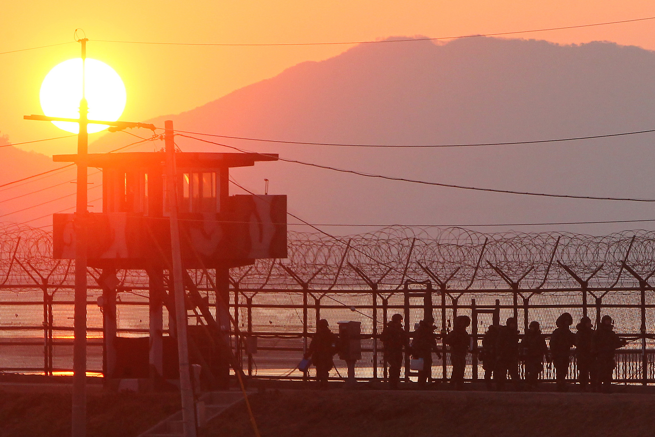 South Korean soldiers patrol along iron fence in Paju near the Demilitarized Zone (DMZ) dividing the two Koreas on Dec. 19, 2011. (Yonhap/AFP/Getty Images)