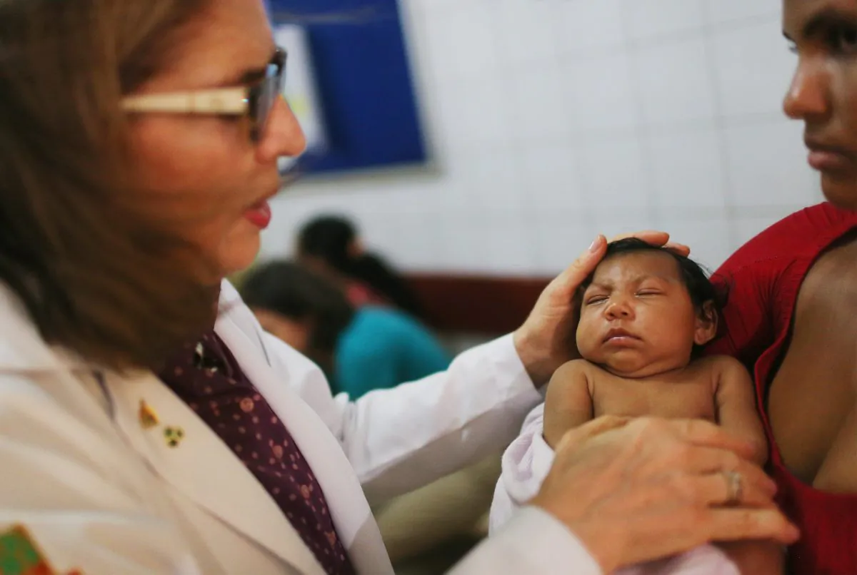 Dr. Angela Rocha (L), pediatric infectologist at Oswaldo Cruz Hospital, examines Ludmilla Hadassa Dias de Vasconcelos (2 months), who has microcephaly, on January 26, 2016 in Recife, Brazil. (Mario Tama/Getty Images)