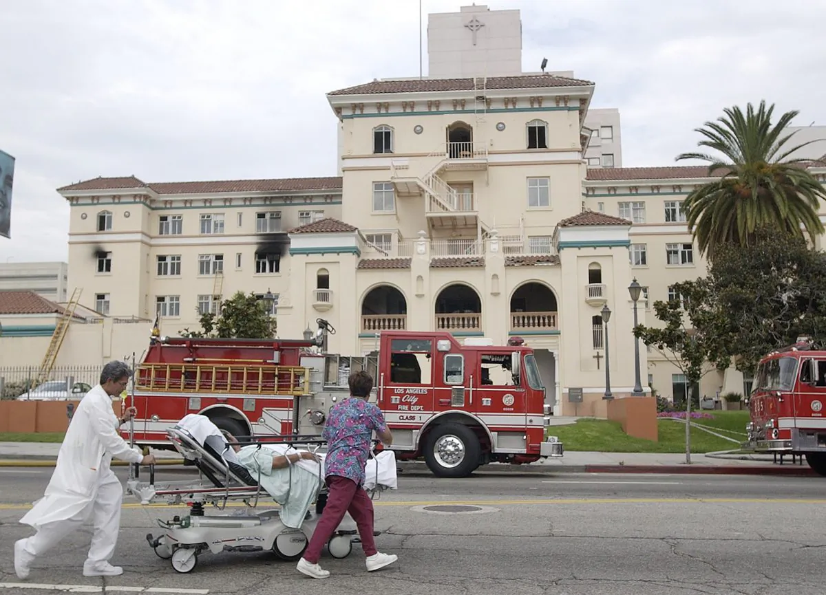 Nurses evacuate a patient after a fire at the Hollywood Presbyterian Medical Center on July 22, 2003. The FBI said on Feb. 17, 2016, it is investigating a computer network extortion plot at the Los Angeles hospital. (AP Photo/Nick Ut)