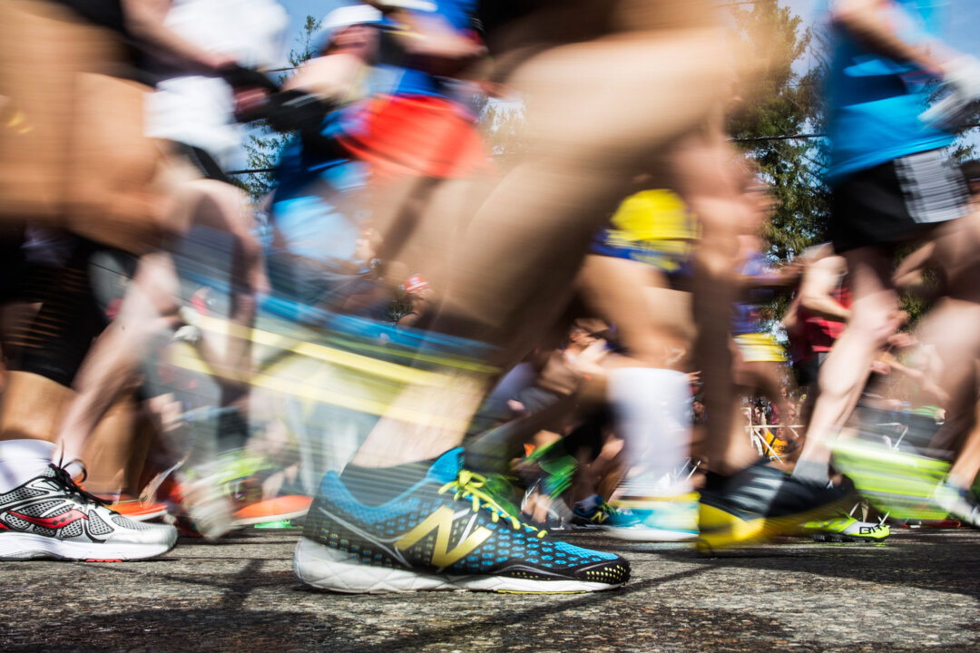 HOPKINGTON, MA - APRIL 21: In this long exposure photograph, runner's shoes are seen at the beginning of the Boston Marathon on April 21, 2014 in Hopkington, Massachusetts. Today marks the 118th Boston Marathon; security presence has been increased this year, due to two bombs that were detonated at the finish line last year, killing three people and injuring more than 260 others. (Photo by Andrew Burton/Getty Images)