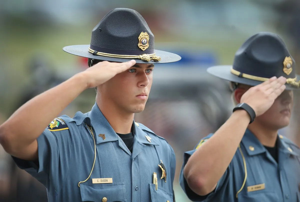 Officers salute as the family of slain Fox Lake police officer Lt. Joe Gliniewicz arrive for a vigil held in his honor in Fox Lake, Ill., on Sept. 2, 2015. Gliniewicz was shot and killed during a foot chase with three suspects. (Scott Olson/Getty Images)