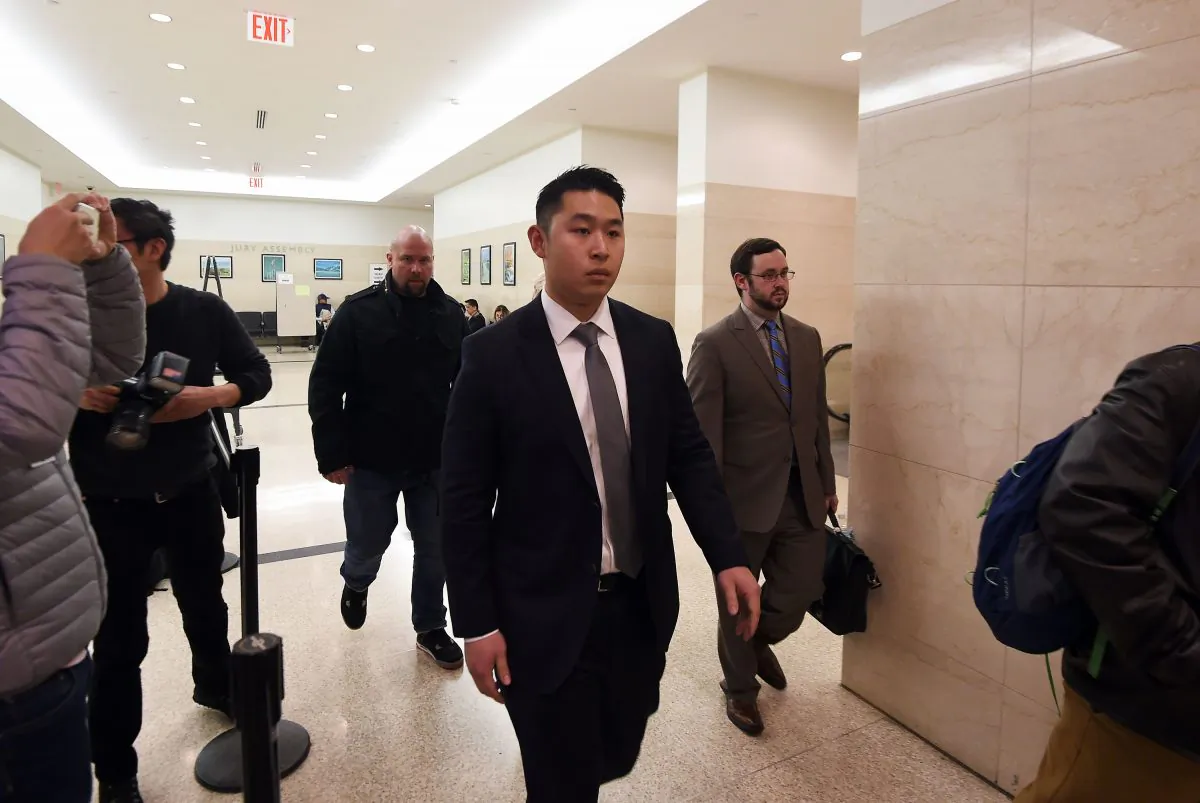 New York Police Department (NYPD) officer Peter Liang (C) arrives at a courtroom in Brooklyn, New York, on Jan. 20, 2016. Rallies will be held in 40 U.S. cities on Feb. 20 after Liang was found guilty of manslaughter. (Jewel Samad/AFP/Getty Images)