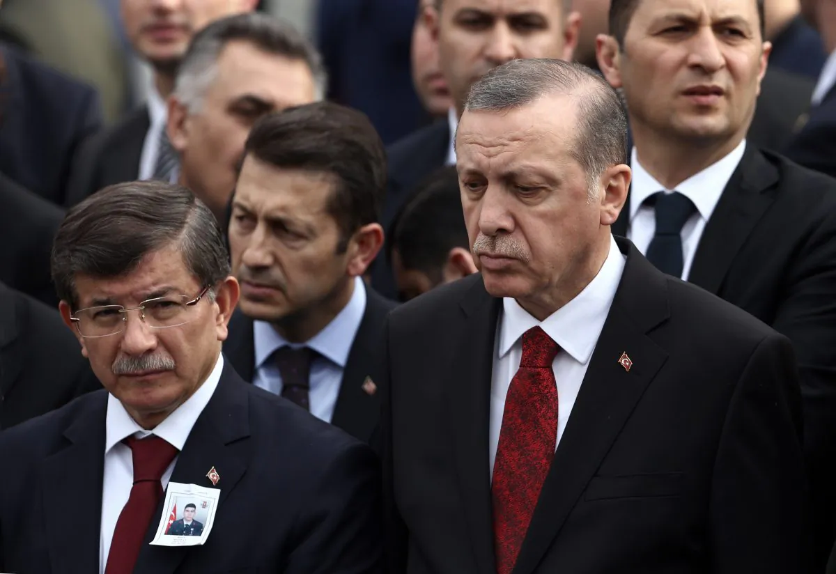 Turkey's President Recep Tayyip Erdogan, right, and Prime Minister Ahmet Davutoglu, left, arrive to attend funeral prayers for army officer Seckin Cil, who was killed in Sur, Diyarbakir Wednesday, in Ankara, Turkey, Thursday, Feb. 18, 2016. Six soldiers were killed after PKK rebels detonated a bomb on the road linking the cities of Diyarbakir and Bingol in southeastern Turkey as their vehicle was passing by, according to Turkeys state-run Anadolu Agency. The deaths come a day after a suicide bombing claimed the lives of at least 28 people and wounded dozens of others.(AP Photo/Burhan Ozbilici)