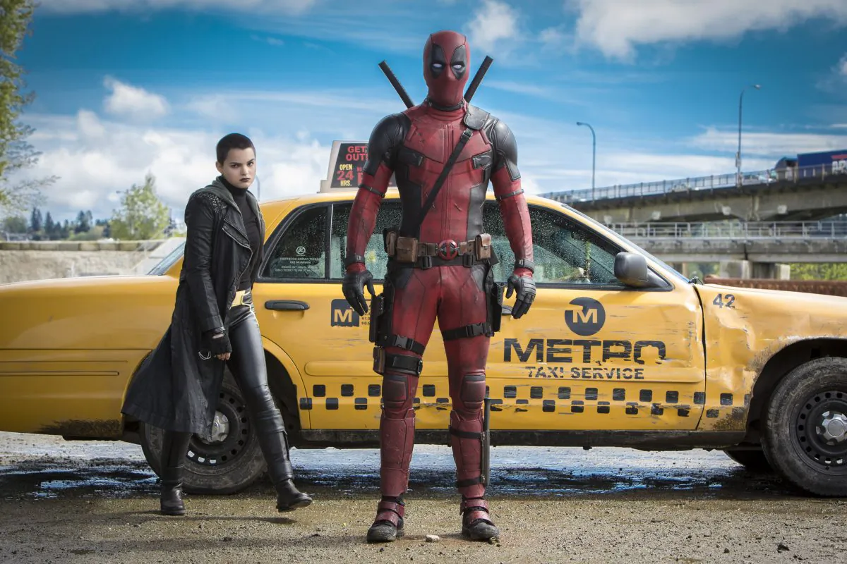 (L–R) Having enjoyed a leisurely cab drive, Deadpool (Ryan Reynolds) is ready for battle, joined by Negasonic Teenage Warhead (Brianna Hildebrand). (TM/© 2015 Marvel & Subs/TM and © 2015 Twentieth Century Fox Film Corporation)