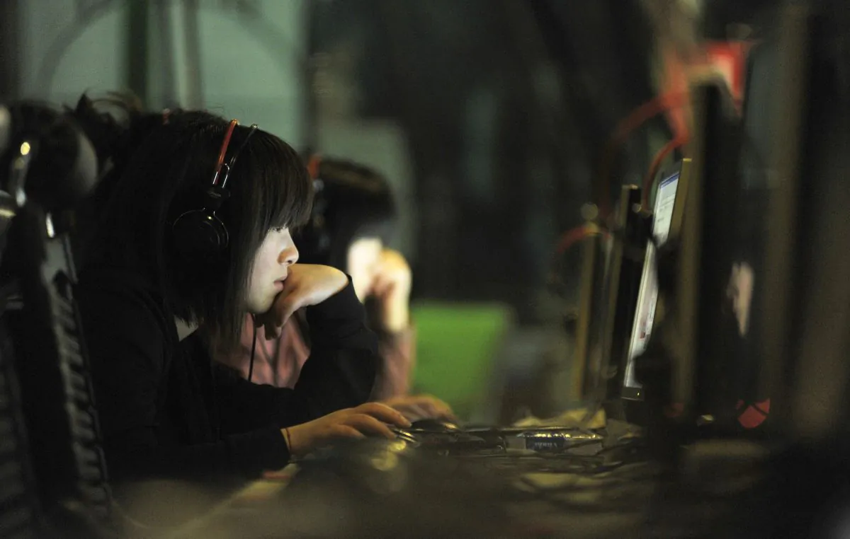 People use computers at an Internet cafe in Beijing. Cybercriminals in China's hacker underground are now going global on the DarkNet. (Gou Yige/AFP/Getty Images)
