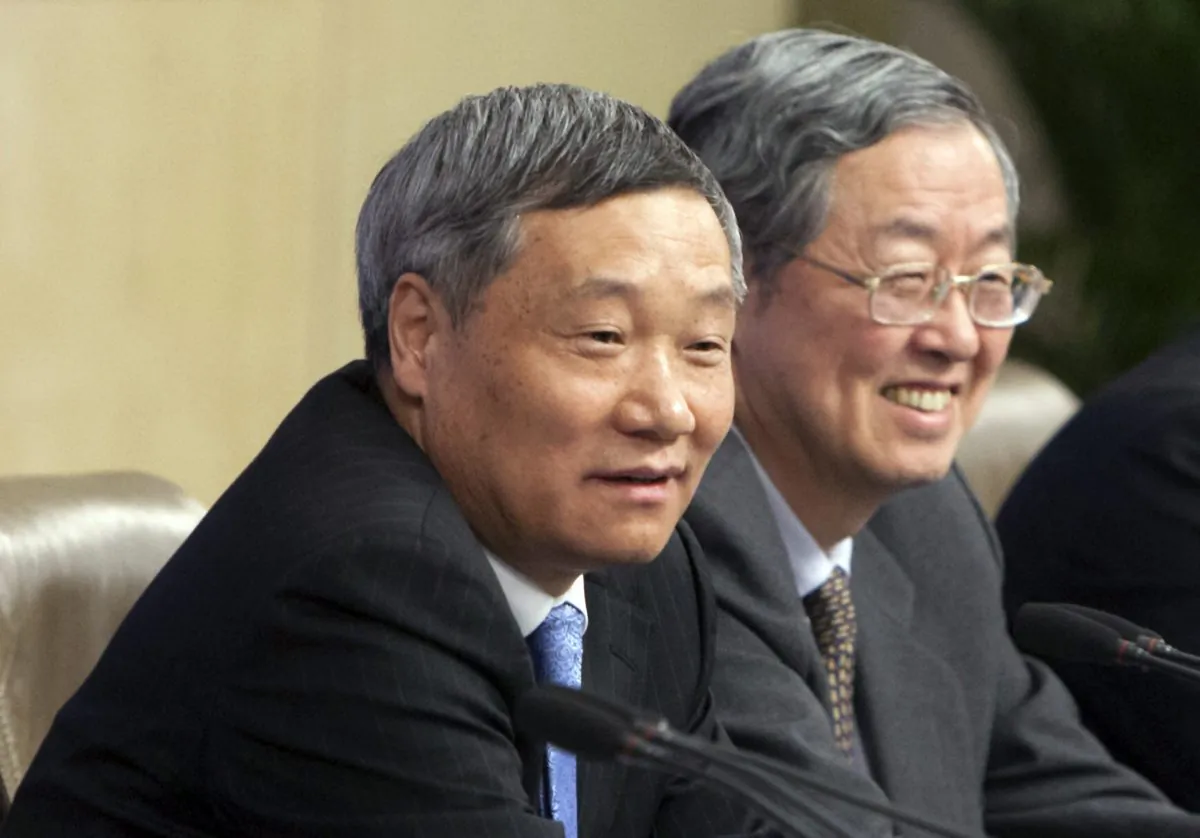 Then head of China Securities Regulatory Commission Xiao Gang (L) and Zhou Xiaochuan, governor of the People's Bank of China, at a press conference in Beijing, China, on March 11, 2014. Xiao who was appointed China's top securities regulator in March 2013 will step down following months of turmoil in the Chinese stock markets, the state-run news agency said Saturday, Feb. 20, 2016. (Chinatopix via AP)