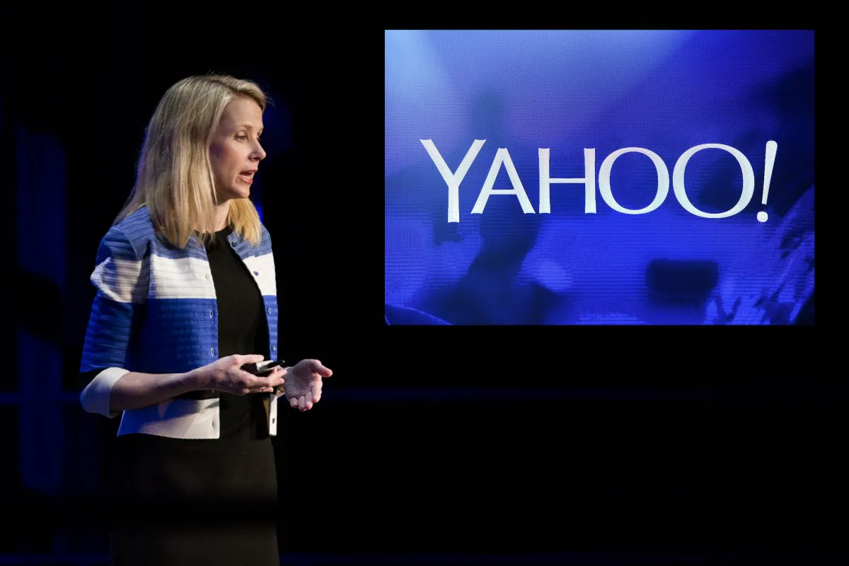 Yahoo! President and CEO Marissa Mayer at the Yahoo Mobile Developers Conference at The Masonic in San Francisco, Calif., on Feb. 18, 2016. Yahoo has recently announced a 15% reduction of its global workforce as the company continues to struggle in the rapidly-changing tech landscape. (Stephen Lam/Getty Images) Top right: A Yahoo! logo at the 2014 International CES at The Las Vegas Hotel & Casino in Las Vegas, Nev., on Jan. 7, 2014. (than Miller/Getty Images)